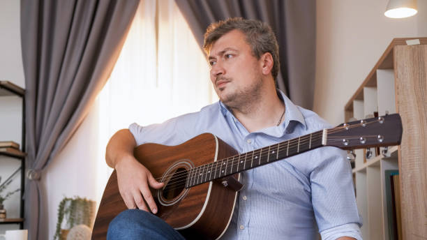 istock Guitar learning music crisis man playing home 2152657680
