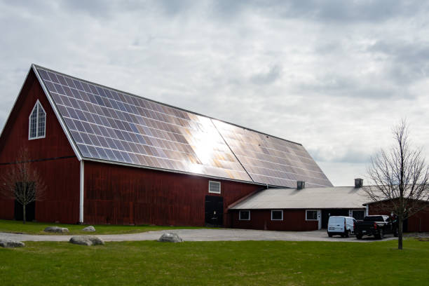 Stockholm, Sweden April 25, 2024 A red barn with solar panels.