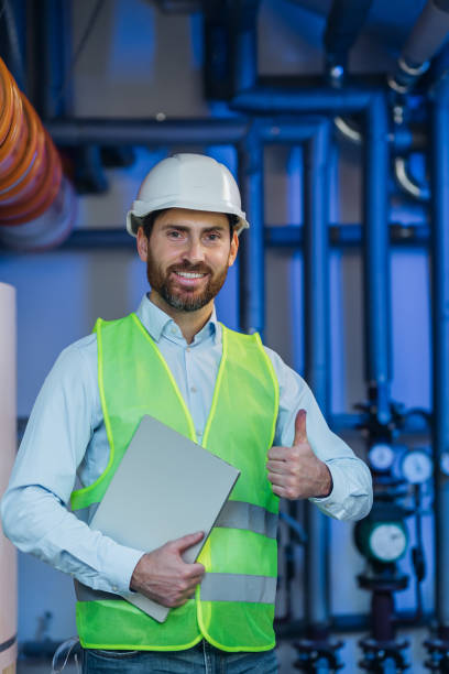istock Engineer show thumb up and hold laptop computer checking and inspecting HVAC heating ventilation air conditioning system 2152658327