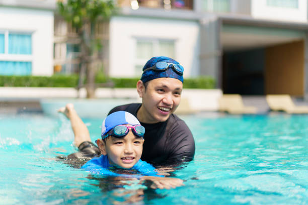 istock Father and child swimming together. 2152660323