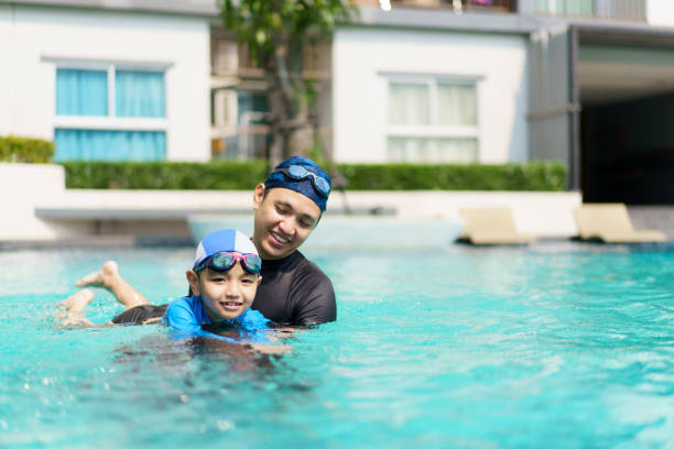 istock Father and child swimming together. 2152660328