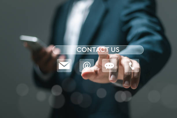 istock Businessman using smartphone with virtual contact us icon or Customer support hotline people connect. Contact us concept. 2152666287