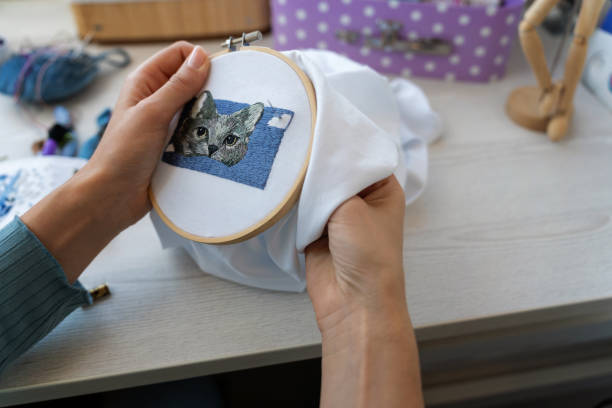 A young woman as she embroiders beauty stitch by stitch, weaving intricate designs with every movement of her needle. This image captures the grace and skill of her craft.