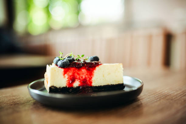 istock Slice of cheesecake with fresh blueberries and jam 2152666388