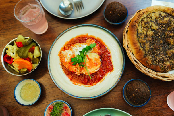 Arabic and Middle Eastern dinner table - Shakshuka, Hummus and Zaatar bread