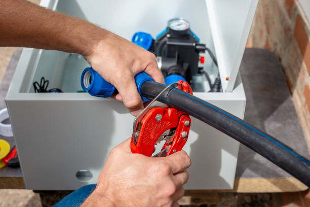 Red Pipe Cutter on Light Blue Background - Hand Tool for Cutting PVC Pipes