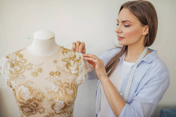 istock Beautiful seamstress is working with a wedding dress model in her studio 2152667921