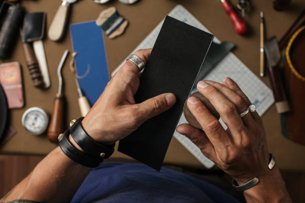 istock Working process of producing hand made leather wallet in the leather workshop. 2152669435