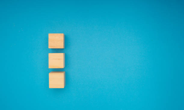 istock Three wooden cubes are on a blue background. 2152672818