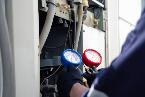 istock Air conditioning, HVAC service technician using gauges to check refrigerant and add refrigerant,Air Conditioning Repair, repairman on the floor fixing air conditioning system. 2152674728