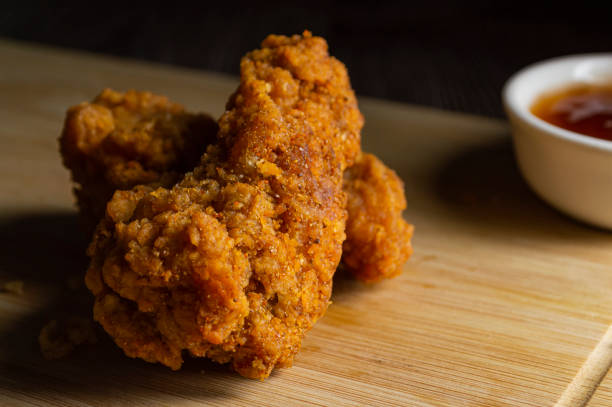 istock Crispy fried chicken on a wooden cutting board 2152674847