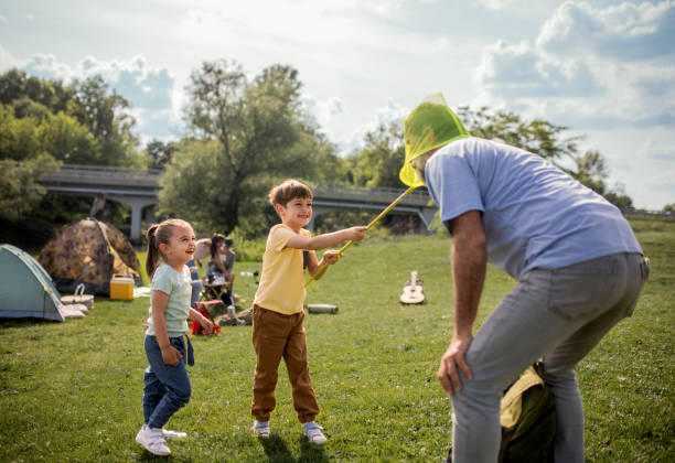 An Asian family enjoys quality time outdoors as their daughter plays ball with her parents. Against a backdrop of rising inflation, shifting gender roles, and evolving family dynamics, this moment highlights resilience, love, and connection in uncertain times. As global economies face tariff disputes and cost-of-living surges, families find strength in shared joy and everyday moments. Perfect for illustrating financial stability, emotional balance, or generational bonding in modern marketing.
