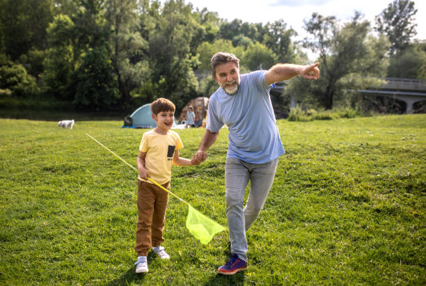 istock a multigenerational family is camping in a park by the river 2152675391