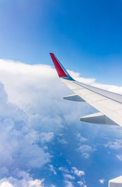 istock View from the airplane window at a beautiful cloudy sky and the airplane wing 2152676048