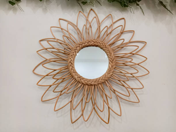 istock Vintage rattan mirror on white textured wall. Rattan mirror on a white background. 2152676210