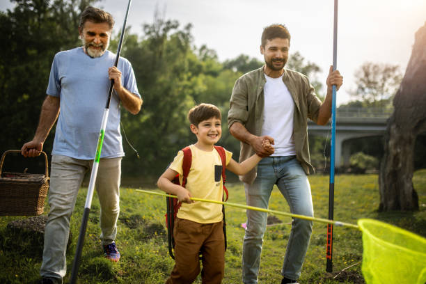 a multigenerational family is camping and they fish in the river