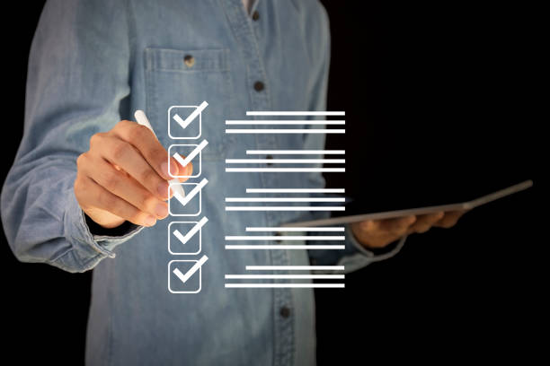 istock checklist Complete the performance review digital form checklist.business people using evaluation questionnaire evaluation 2152678029