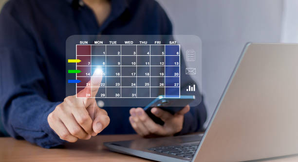 istock Businessman sets agenda on calendar as appointment planning concept. 2152678086