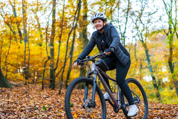 istock Woman riding bicycle in forest 2152679821