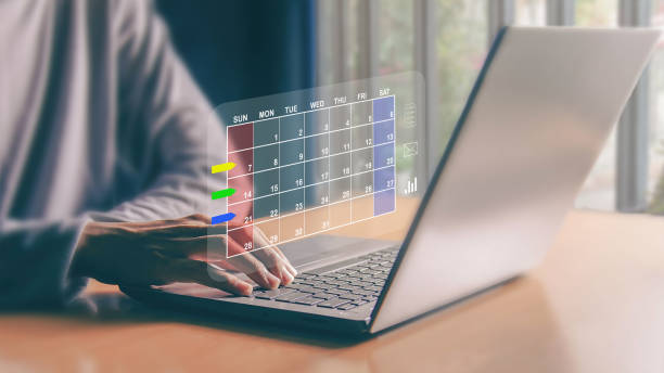 Businessman sets agenda on calendar as appointment planning concept.