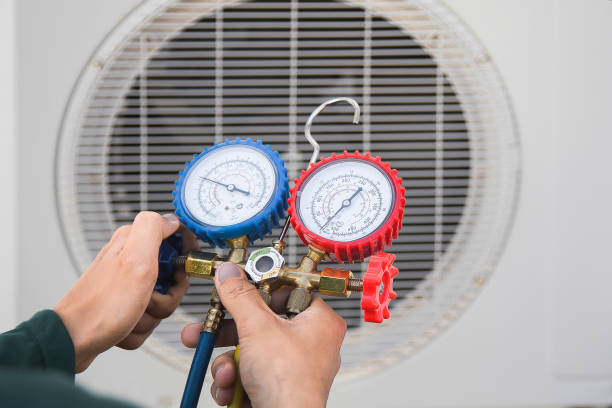 istock Air conditioning, HVAC service technician using gauges to check refrigerant and add refrigerant. 2152681331