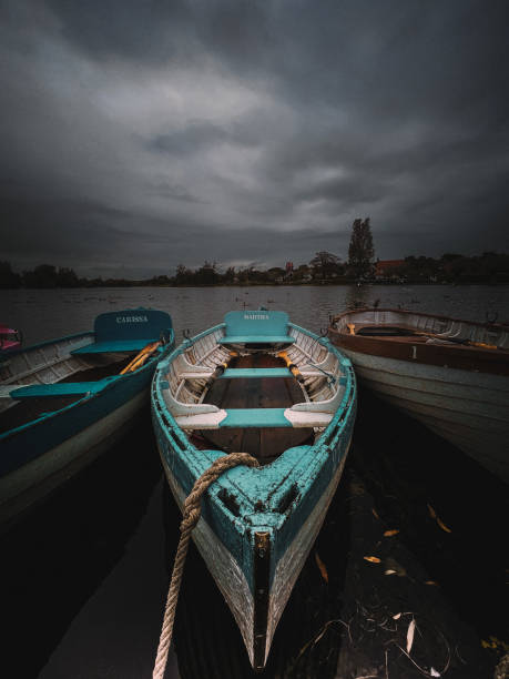 istock Old Colourful Rowboat docked on lake 2152684546