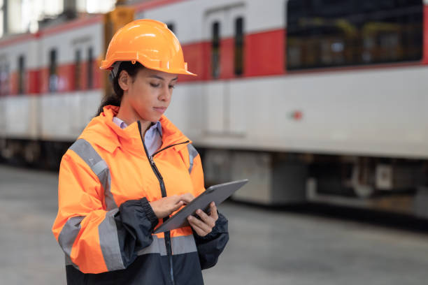 istock Engineer reviews data, updates train maintenance, and ensures safety for quality rail service. 2152684721