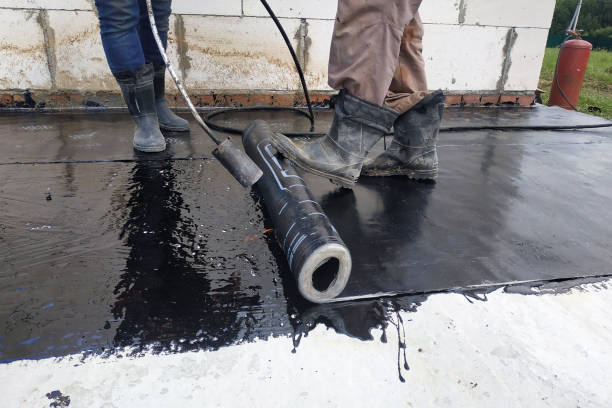 istock The workers cover the concrete screed with bituminous liquid solution and stele the waterproofing. 2152688500