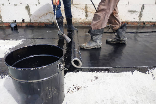 istock The workers cover the concrete screed with bituminous liquid solution and stele the waterproofing. 2152688509