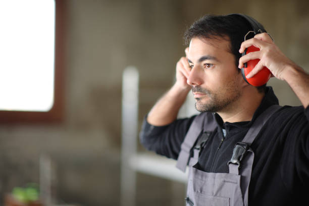 Consruction worker putting noise cancellation headphone