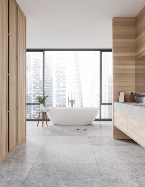 istock Stylish home bathroom interior with tub, sink with accessories and window 2152689838