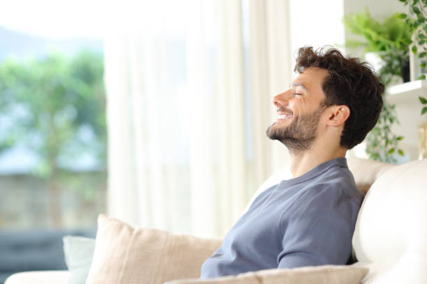 istock Happy man breathing and rekaxing on the couch 2152689872
