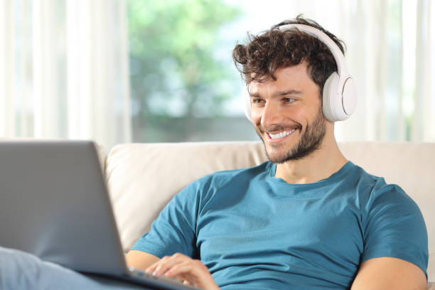 istock Happy man watching media on laptop sitting at home 2152689921