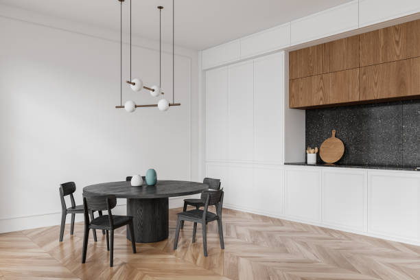 istock A modern kitchen interior with a round table, chairs, and pendant lighting on a plain background, concept of home design. 3D Rendering 2152690249