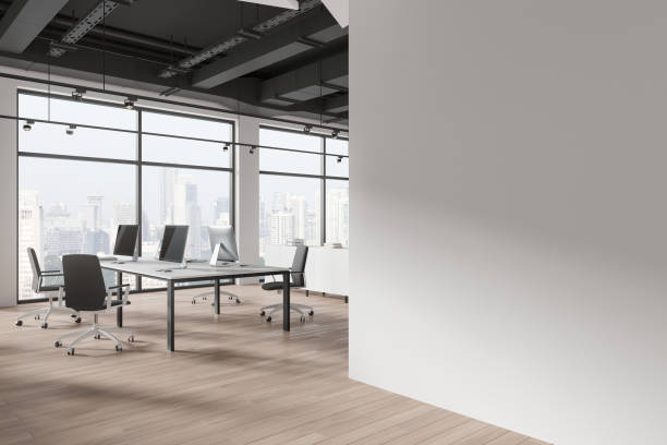 istock Modern office interior with desks, computers, chairs, large windows with a city view, and a blank wall, 3D Rendering. 2152690582