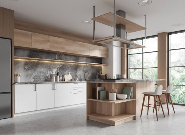 istock Modern home kitchen interior with bar island and cooking cabinet, window 2152691525