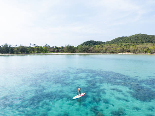 istock Solo Paddleboarding in Crystal Clear Island Waters 2152693346