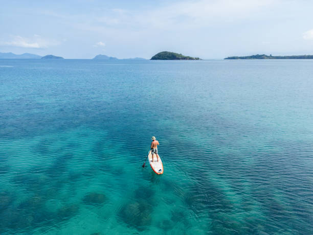 istock Solitary Paddleboarding in Vast Turquoise Seas 2152693374