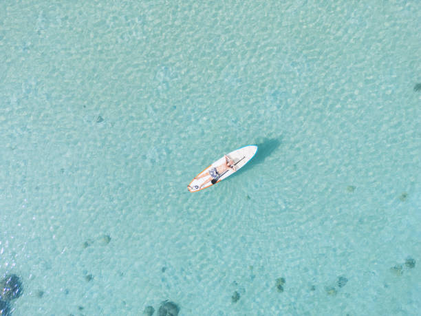 istock Man lying down on a floating paddleboard with arms behind his head 2152693468