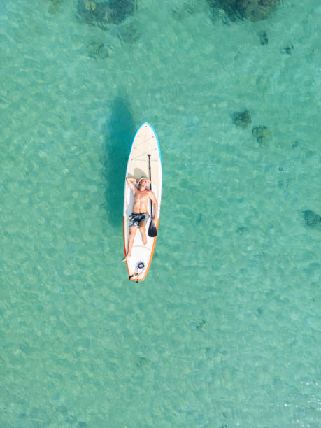 istock Serene Solo Paddleboard Adventure in Clear Waters 2152693485
