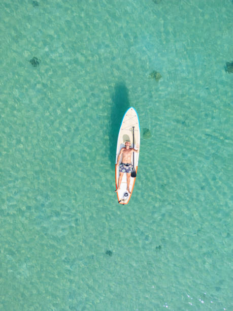 istock Solitary Paddleboarder in Shimmering Turquoise Sea 2152693490