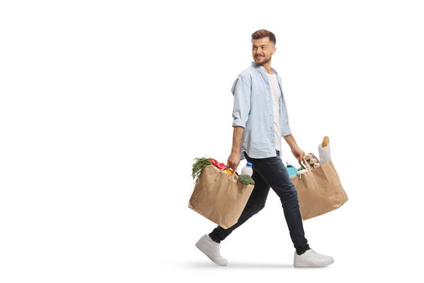 istock Young man walking with grocery bags 2152693544