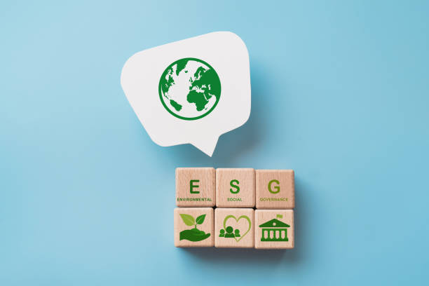 wooden cube blocks with ESG icon and text, green earth icon on white speech bubble. For ESG concept of environmental, social and governance. Sustainable corporation development.