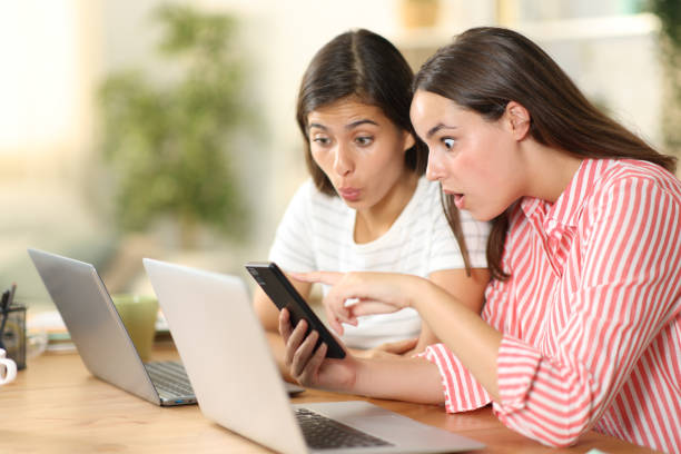 istock Amazed tele workers watching phone content at home 2152693846