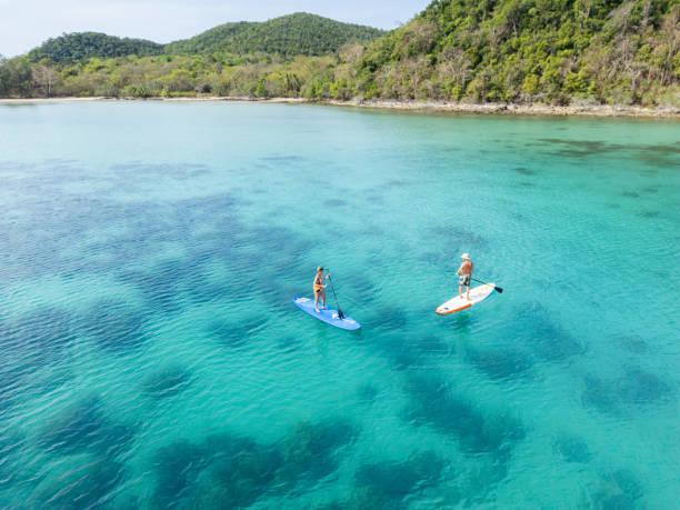 istock Couple Paddleboarding in a Secluded Coastal Bay 2152693913