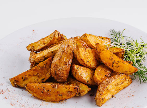 istock Spicy roasted potato wedges on white plate 2152693938
