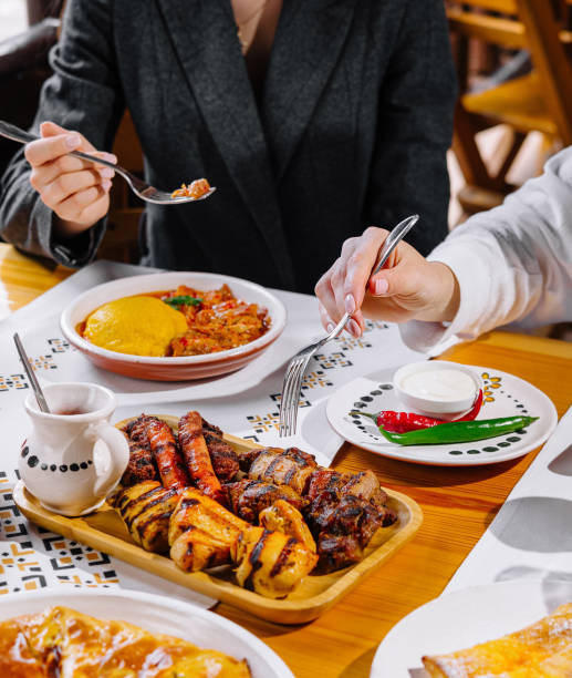 istock Friends enjoying a feast at a restaurant 2152693952