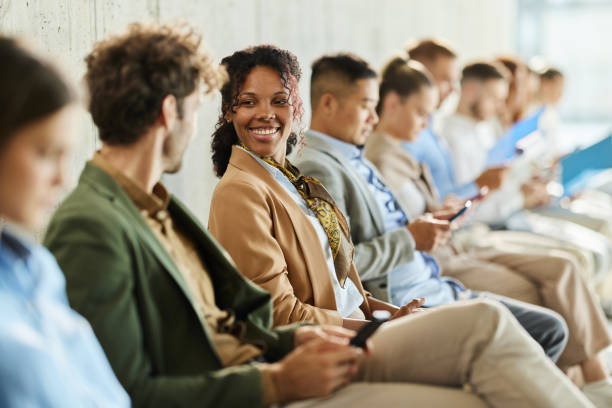istock Happy business colleagues talking while waiting for job interview. 2152693975