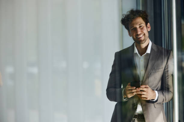 istock Young happy businessman using cell phone in the office. 2152694099