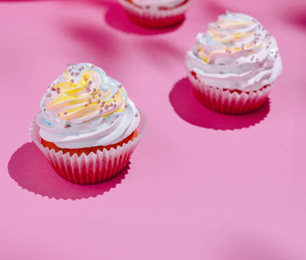 istock Colorful cupcakes on pink background 2152694266